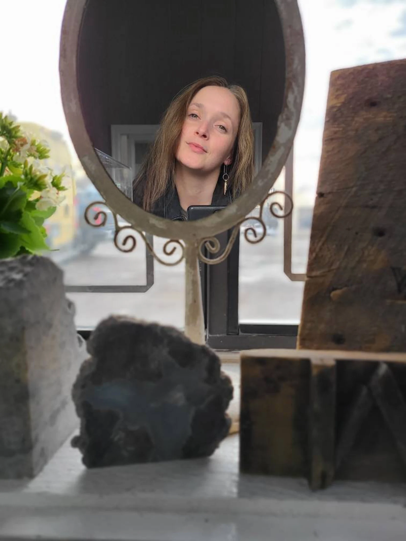 Woman Looking in Mirror at Tassel Dangly Hoop Handcrafted Earrings