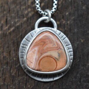 Orange Lake Superior agate set in sterling silver with a sunburst around the setting