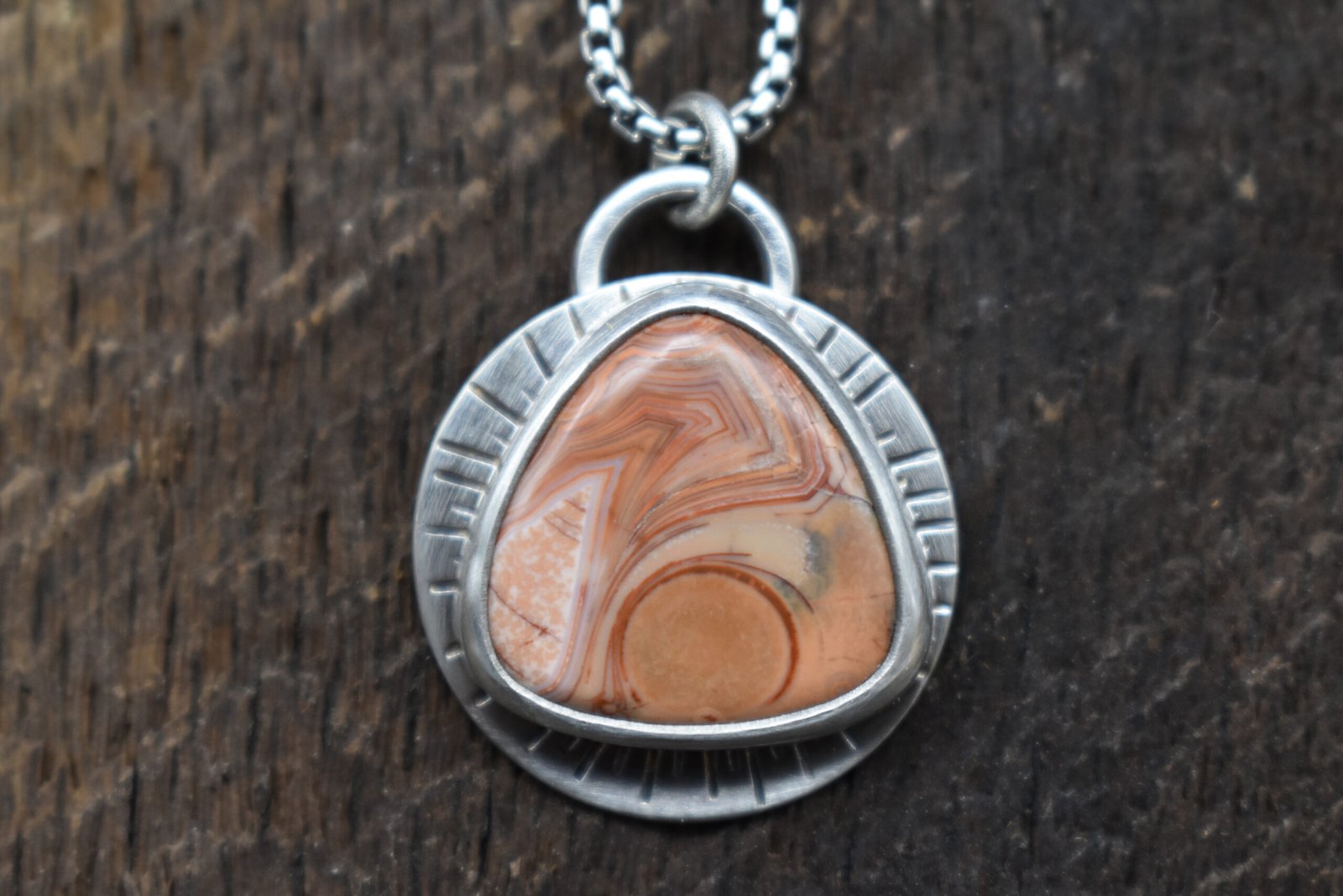 Orange Lake Superior agate set in sterling silver with a sunburst around the setting