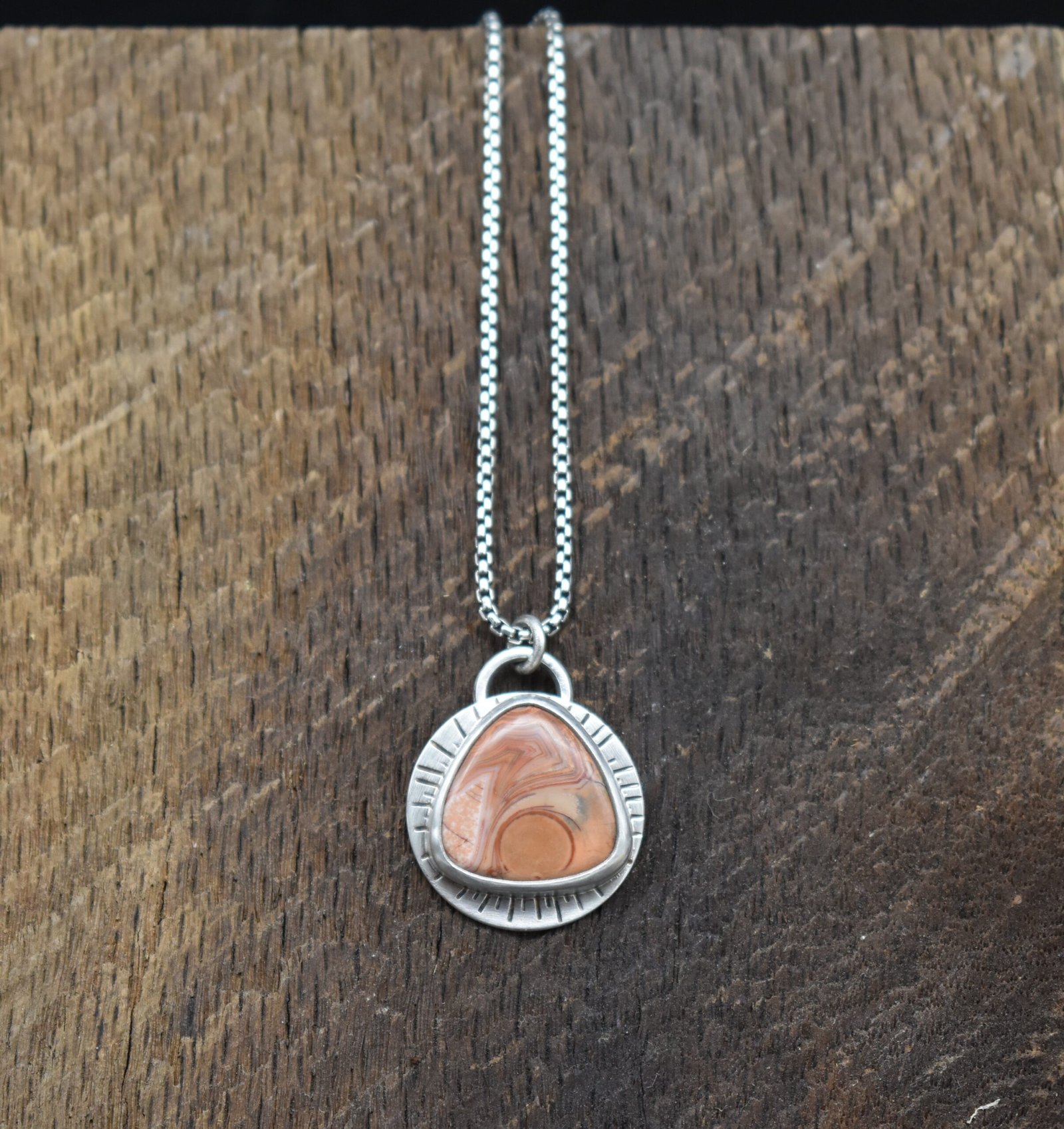 Orange Lake Superior agate set in sterling silver with a sunburst around the setting