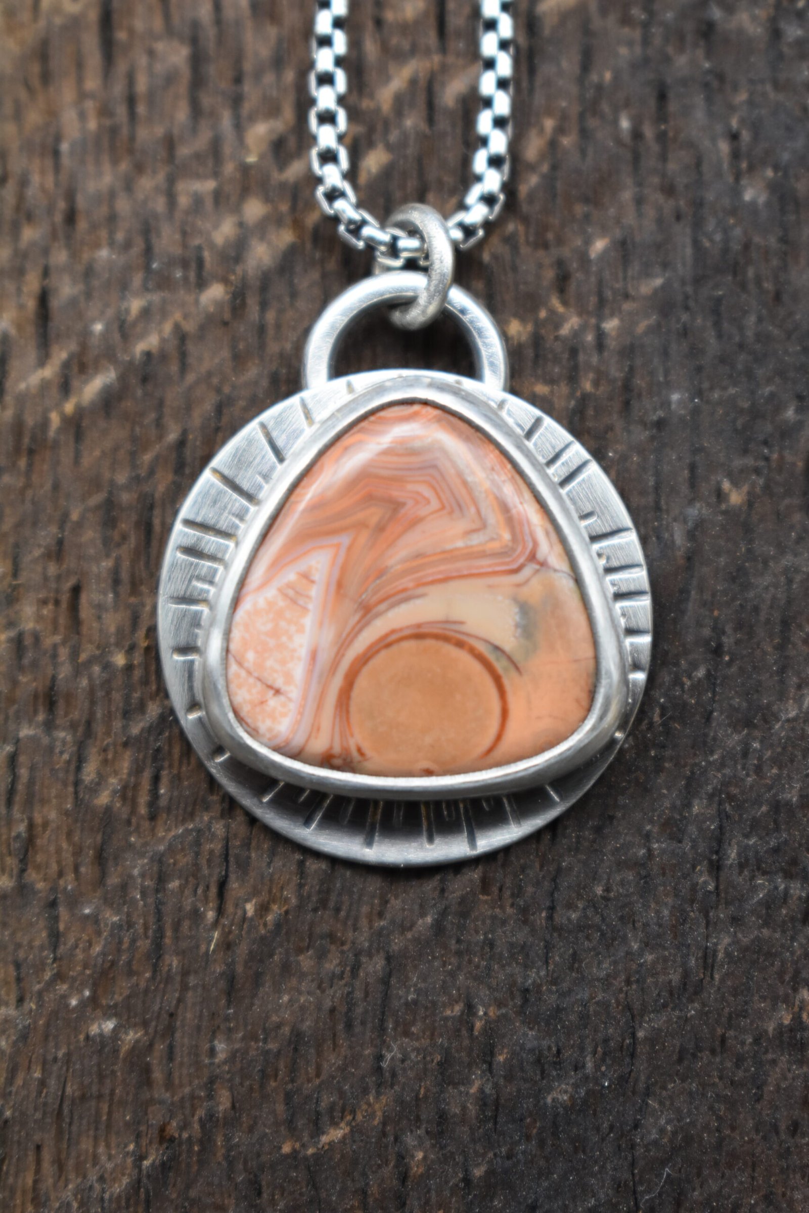 Orange Lake Superior agate set in sterling silver with a sunburst around the setting