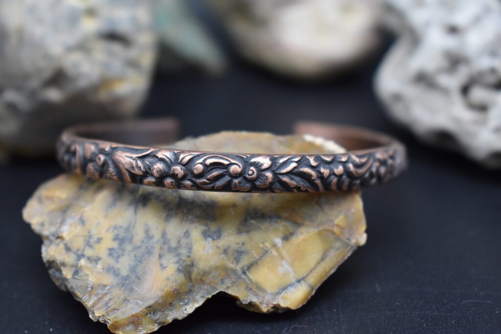 Handmade Copper Cuff Bracelet with a floral pattern and rustic patina finish